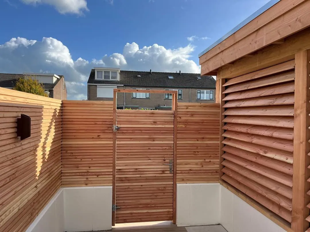 Tuin met houten poort en schermen